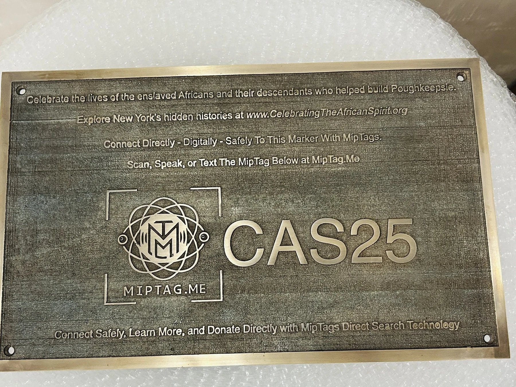 CAS25 engraved on a historical community plaque